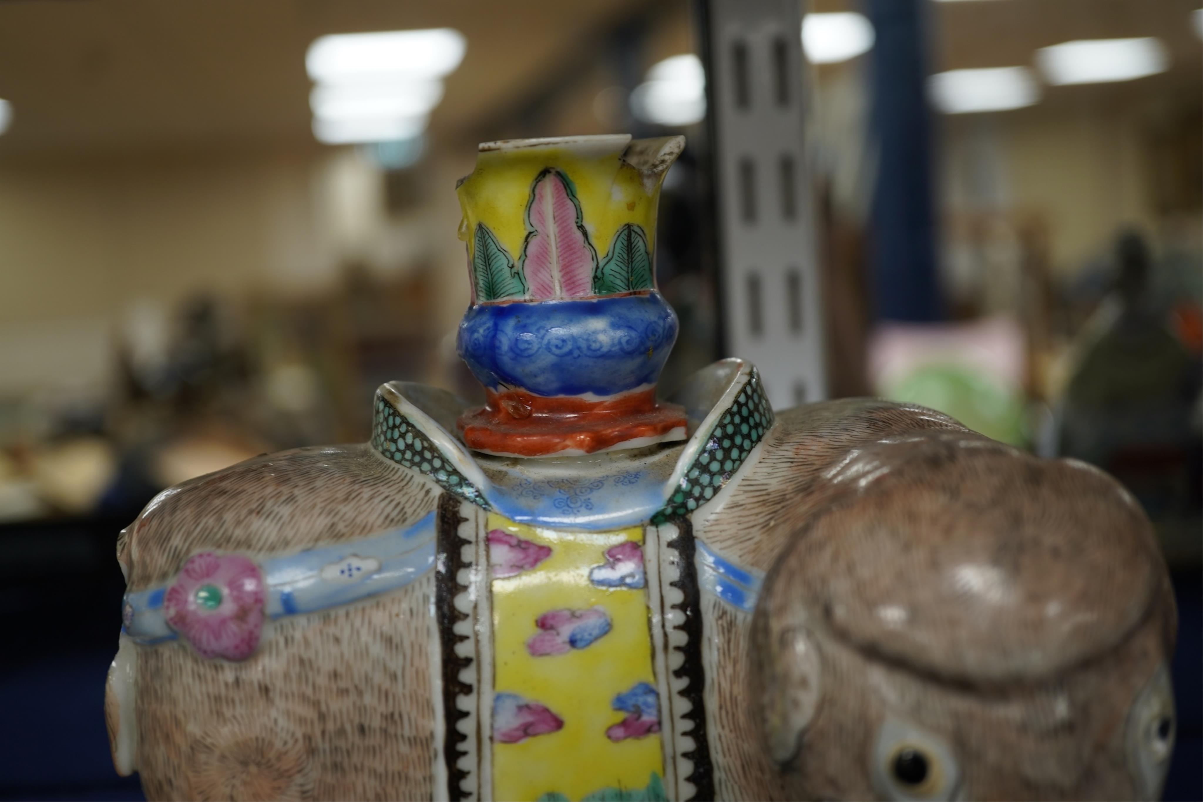 A 19th century Chinese enamelled porcelain vase in the form of an elephant with a howdah on its back